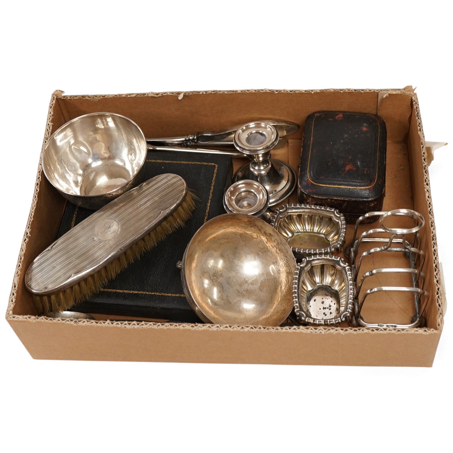 A small group of assorted silver and white metal items including a cased matched pair of Victorian silver pepperettes, an Edwardian silver five bar toastrack, a pair of late Victorian silver salts by William Hutton & Son